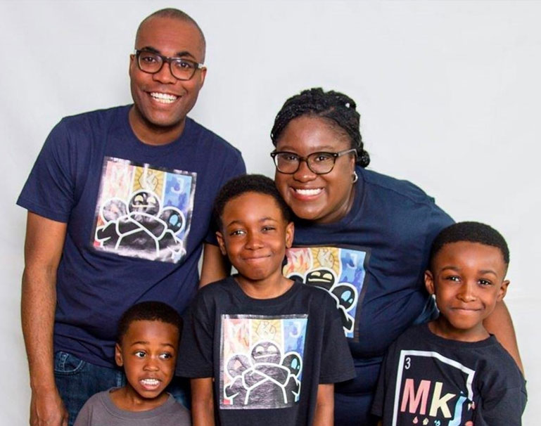 Three brothers and their parents standing together, smiling and looking at the camera