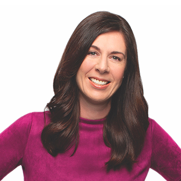 Headshot of Heather Badenoch with long brown hair and a purple long sleeve shirt.