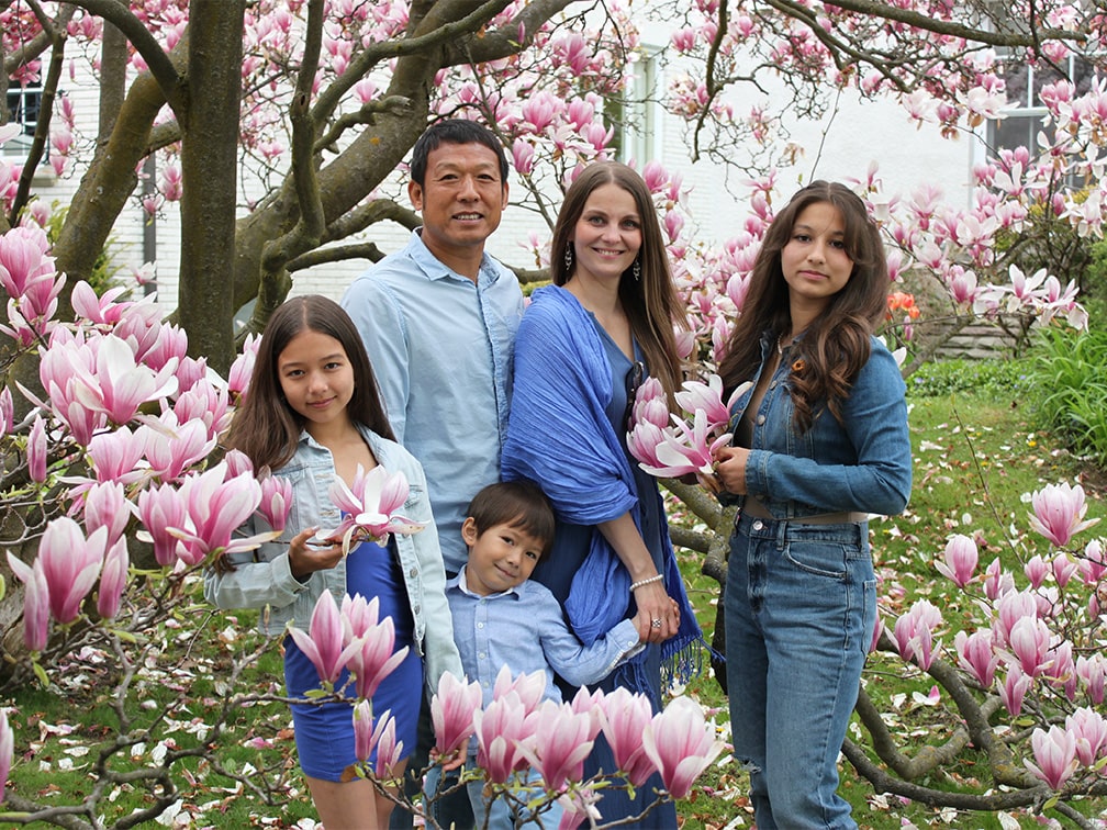 Family of five in garden with pink flowers
