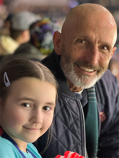 Ralph and Granddaughter at a hockey game