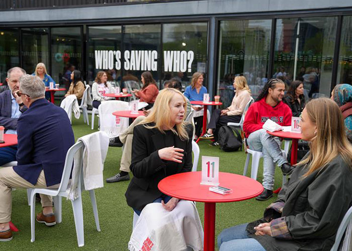 People sitting down at the Who's Saving Who' launch party