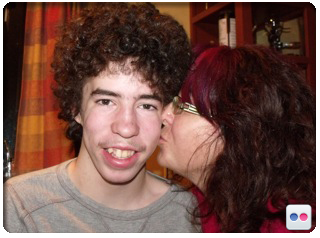 Robbie Thompson Image of organ recipient Robbie Thompson and his mom, Sue Thompson giving Robbie a kiss on his cheek