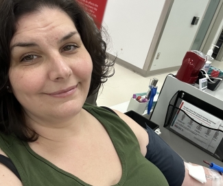 Blood donor next to machine for blood collection