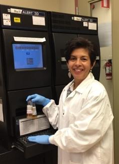 Dr. Ramirez  in the lab with the BacT/ALERT bacterial screening system.