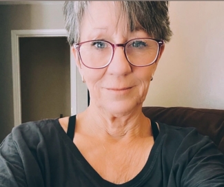Blood donor in black shirt and glasses