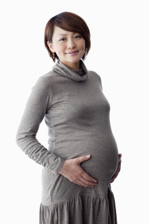 pregnant woman holding her stomach