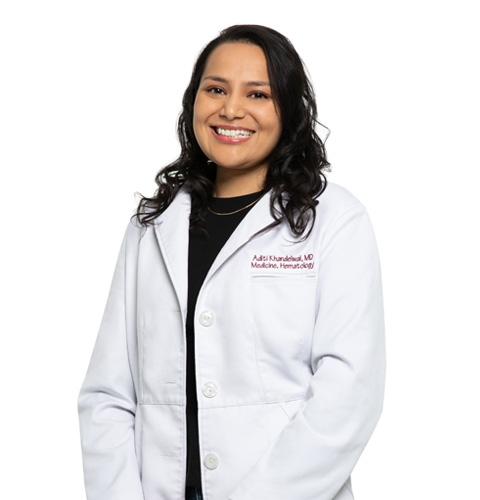 Dr. Aditi wearing a lab coat