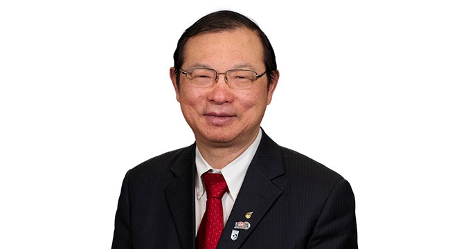 Headshot of Heyu Ni in a red tie and black blazer