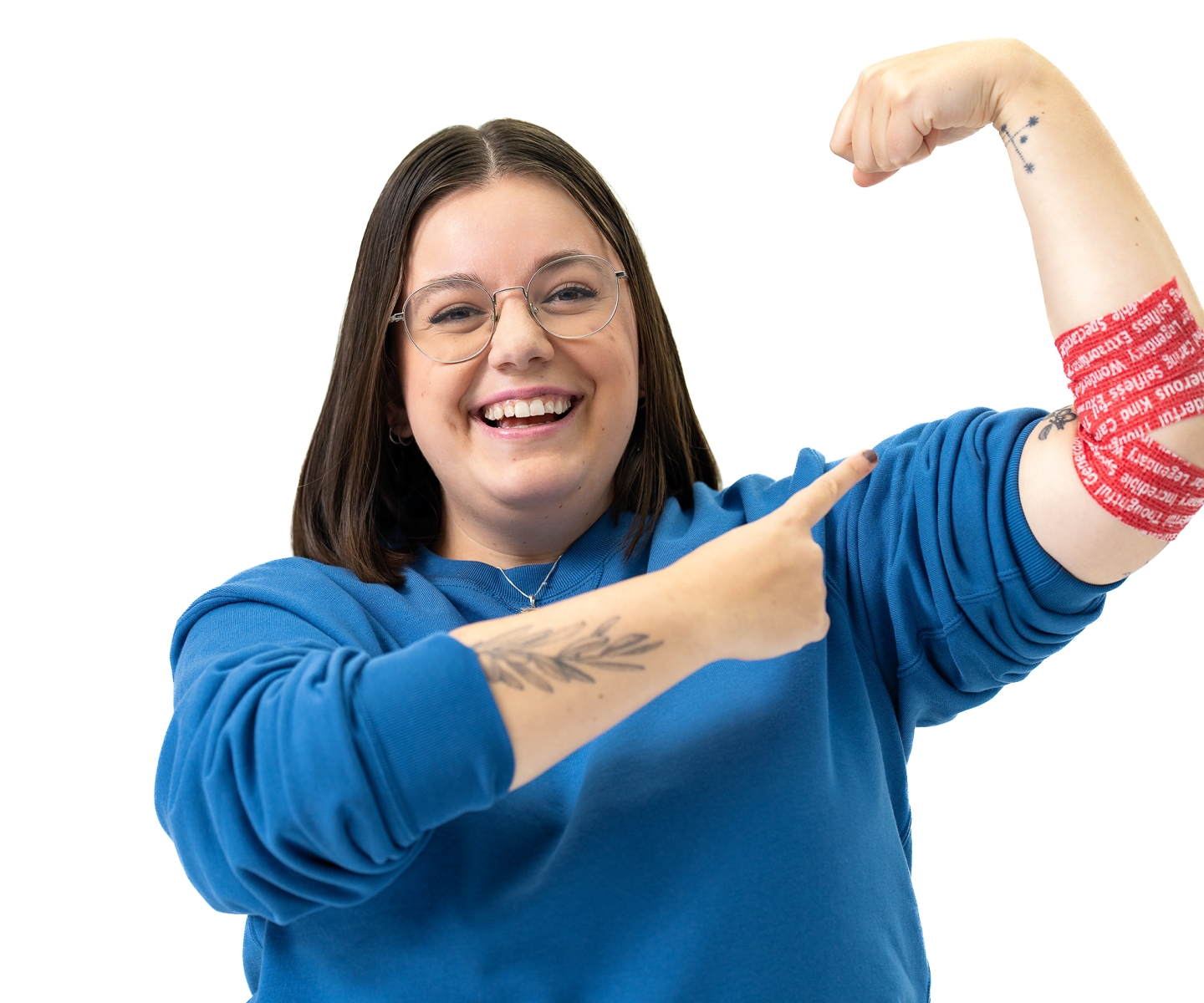 First-time donor Corina pointing at arm bandage