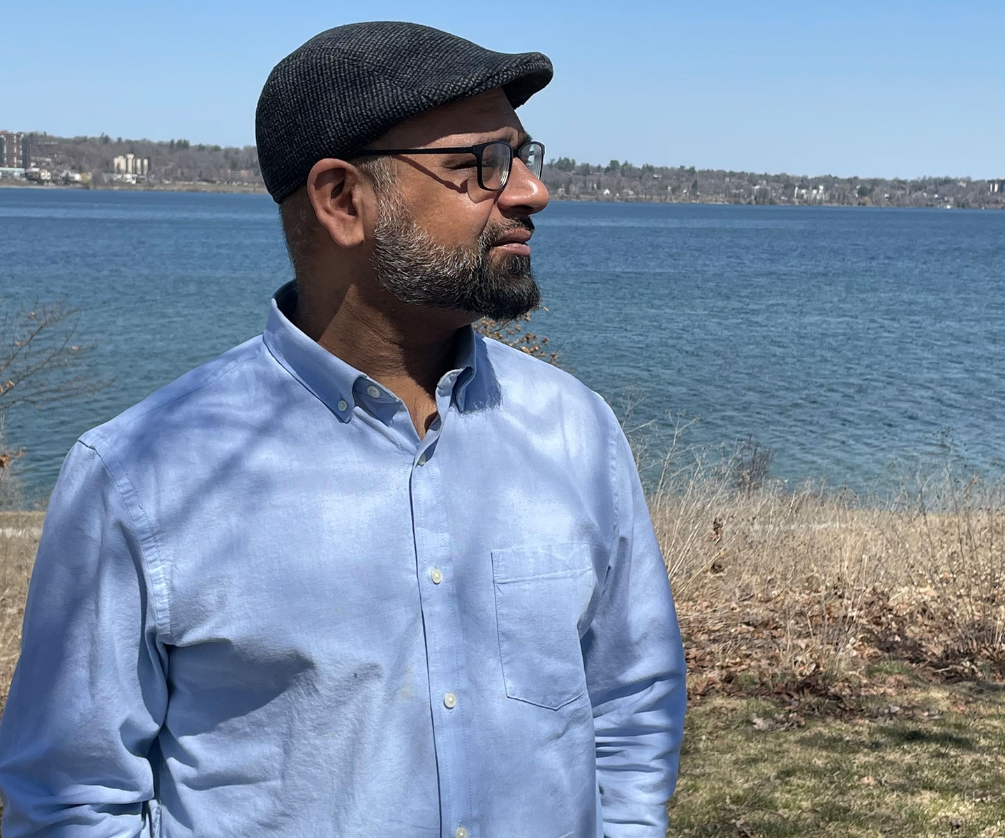 Man looking into distance at shore of Lake Simcoe