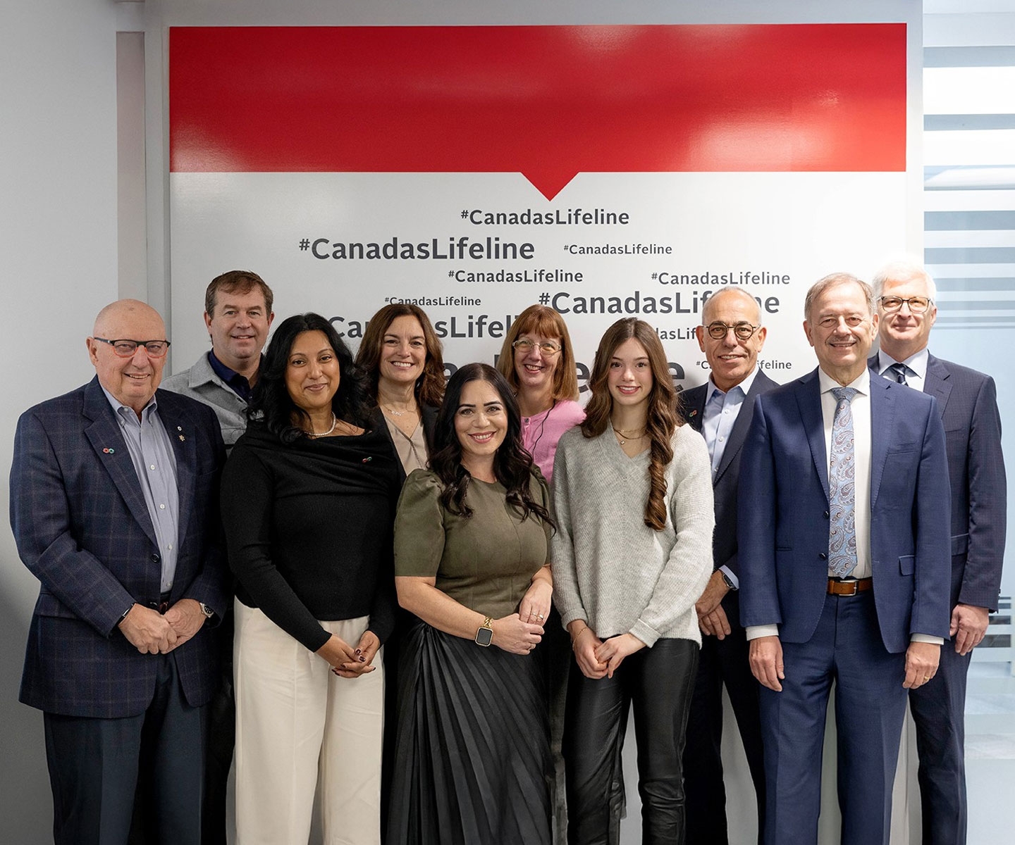 National Award recipients and Canadian Blood Services executives in front of a backdrop that says #CanadasLifeline.