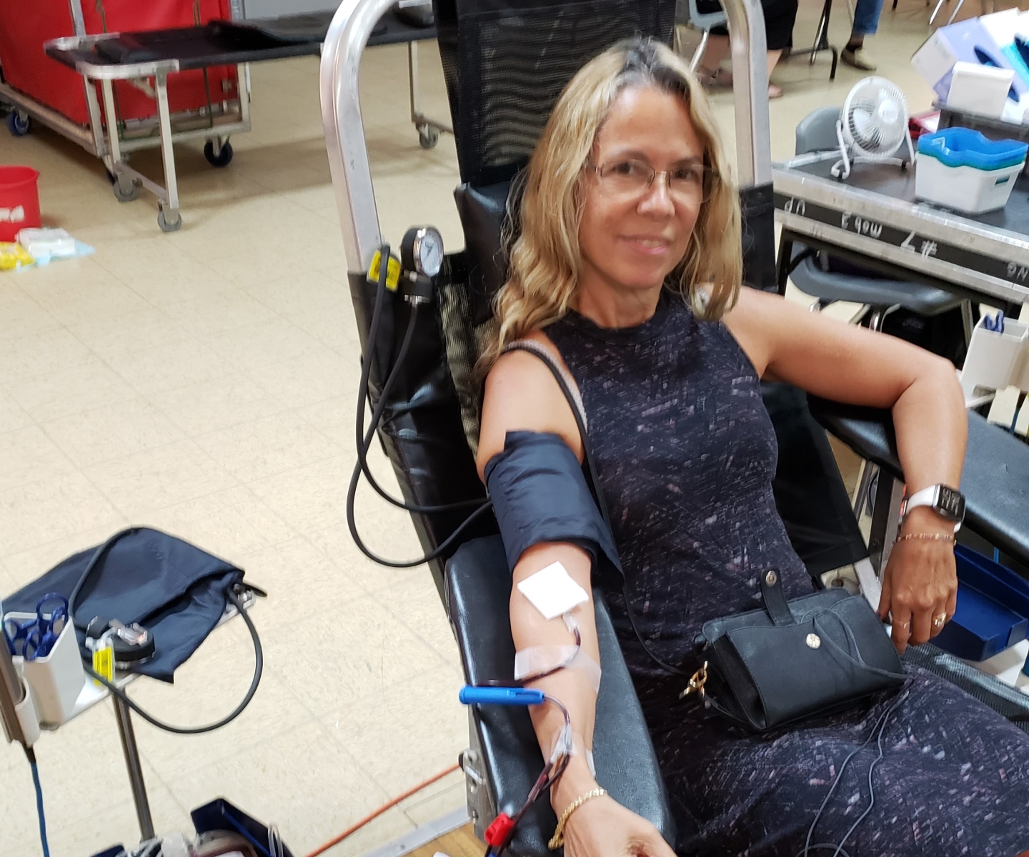 Blood donor in chair donating blood