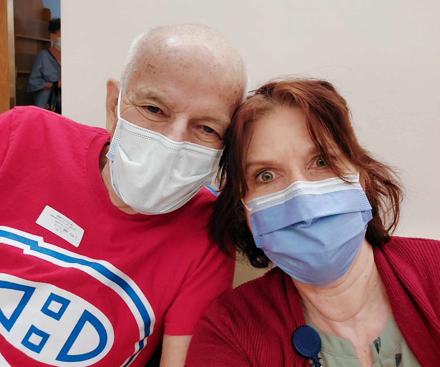 Woman with her dad wearing surgical masks