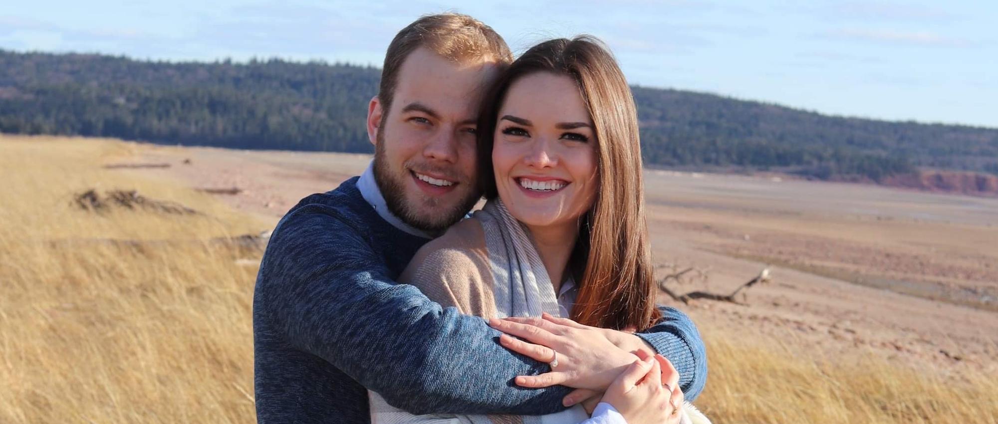 Lizzy Burns and her fiancé Ryan Doucet stand together in a field of yellow grasses. Lizzy Burns successfully donated stem cells in December 2020.