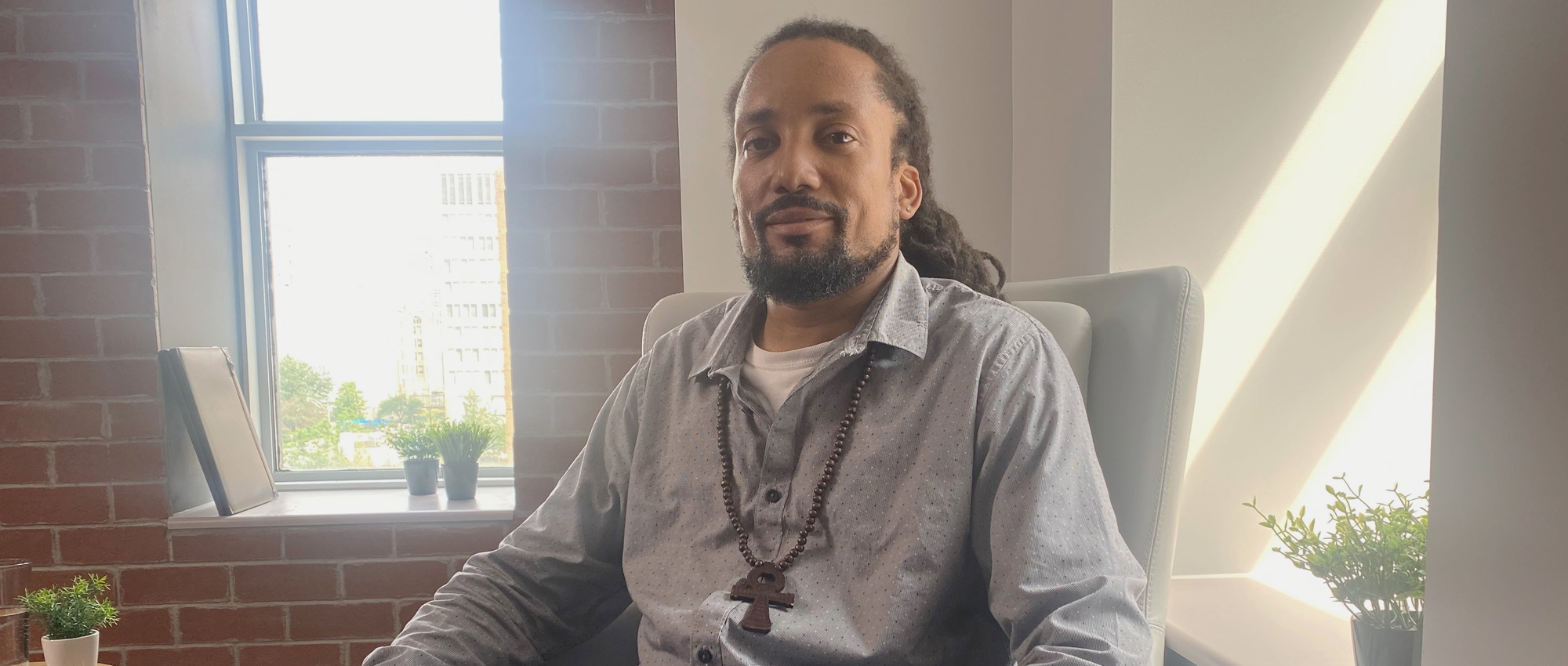 Man with sickle cell disease sits in an office in Toronto