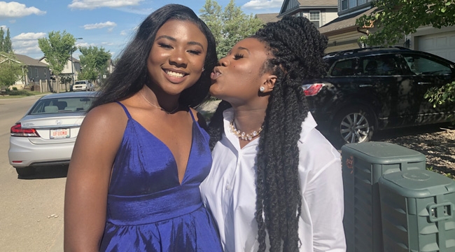 Stem cell recipient kisses her sister Nyerhovwo on the cheek