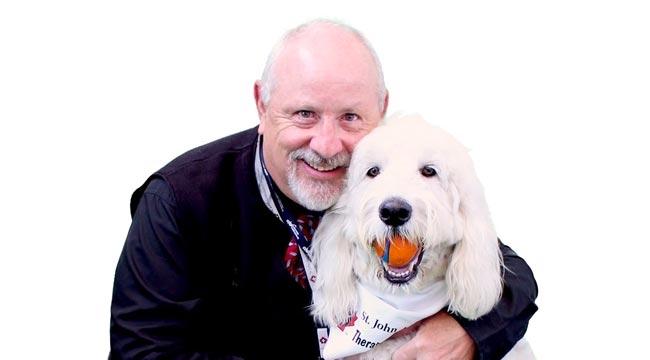 A therapy dog with his male handler