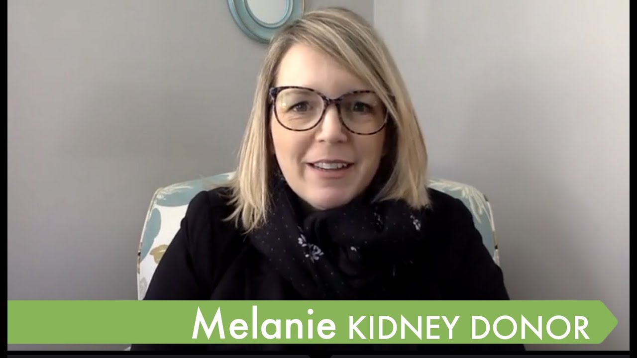 Link to Youtube video of Melanie, kidney donor.  Thumbnail shows a woman with blonde hair and glasses, wearing a black shirt, smiling.